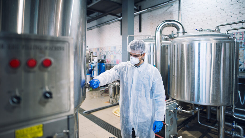 experienced-technologist-white-protective-uniform-holding-tablet-controlling-food-manufacturing-processing-factory